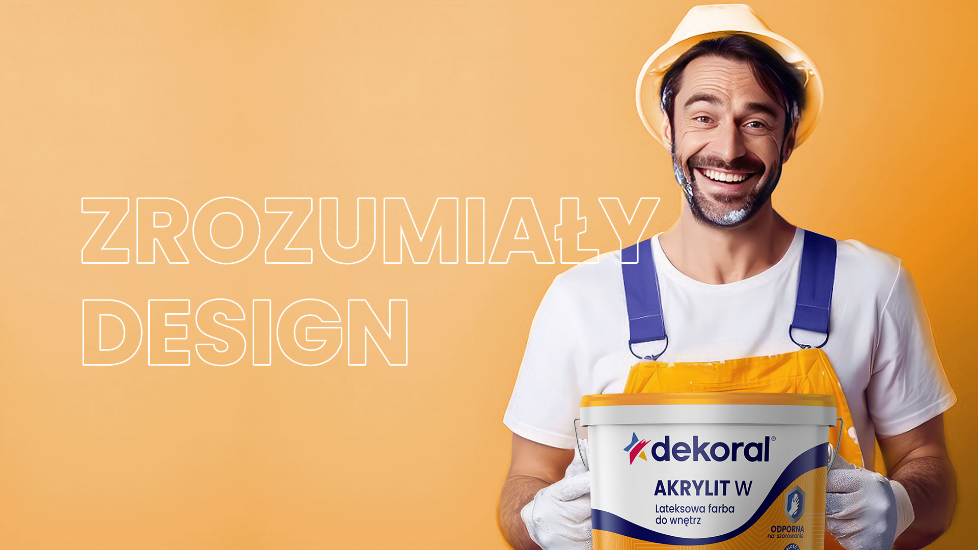 Dekoral rebranding - uśmiechnięty mężczyzna z puszką farby akrylit w rękach
